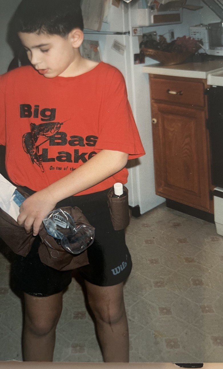 Evan as a child wearing his first invention, a utility belt for a cold